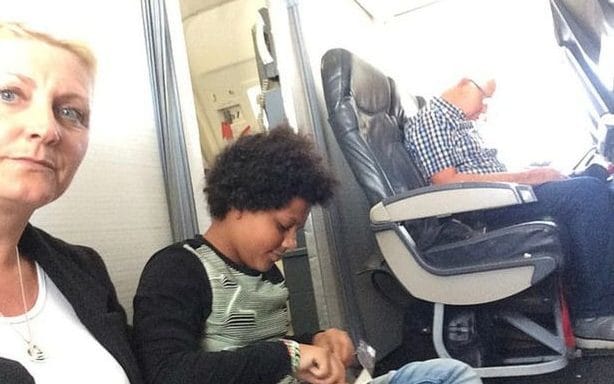 a boy sitting on a plane